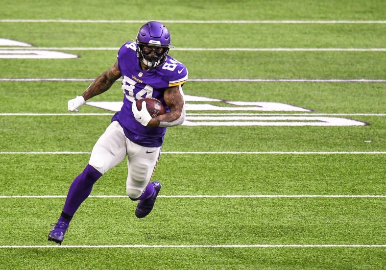 Oct 18, 2020; Minneapolis, Minnesota, USA;  Minnesota Vikings tight end Irv Smith Jr. (84) runs with the ball after a catch for a 36-yard gain in the first quarter against the Atlanta Falcons at U.S. Bank Stadium. Mandatory Credit: Nick Wosika-USA TODAY Sports