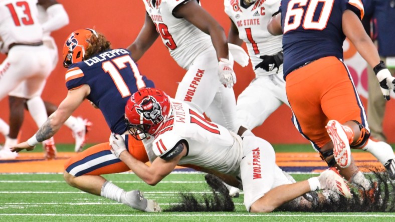 Nov 28, 2020; Syracuse, New York, USA; North Carolina State Wolfpack linebacker Payton Wilson (11) sacks Syracuse Orange quarterback Rex Culpepper (17) in the fourth quarter at the Carrier Dome. Mandatory Credit: Mark Konezny-USA TODAY Sports