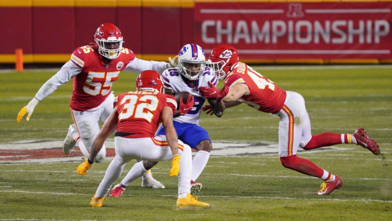 Jan 24, 2021; Kansas City, MO, USA; Buffalo Bills wide receiver Isaiah McKenzie (19) runs between Kansas City Chiefs strong safety Tyrann Mathieu (32), defensive end Frank Clark (55) and free safety Daniel Sorensen (49) during the fourth quarter in the AFC Championship Game at Arrowhead Stadium. Mandatory Credit: Denny Medley-USA TODAY Sports