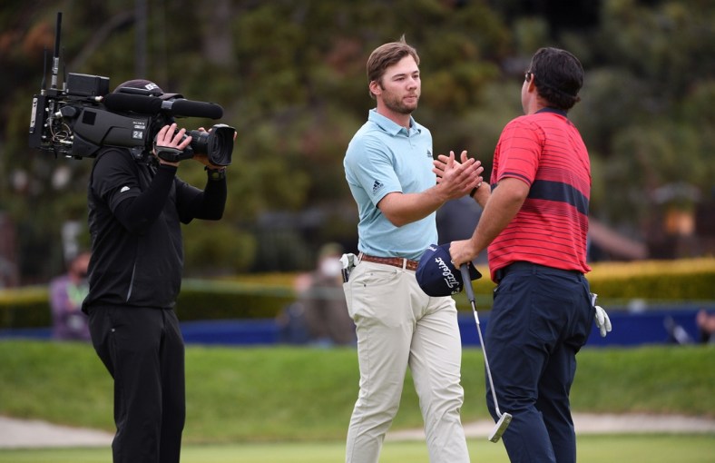 Jan 31, 2021; San Diego, California, USA; Sam Burns (C) and Patrick Reed (R) shake hands following their final round of the Farmers Insurance Open golf tournament at Torrey Pines Municipal Golf Course - South Course. Mandatory Credit: Orlando Ramirez-USA TODAY Sports