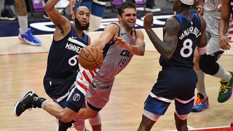 Feb 27, 2021; Washington, District of Columbia, USA; Washington Wizards guard Raul Neto (19) passes between Minnesota Timberwolves guard Jordan McLaughlin (6) and forward Jarred Vanderbilt (8) during the second quarter at Capital One Arena. Mandatory Credit: Brad Mills-USA TODAY Sports