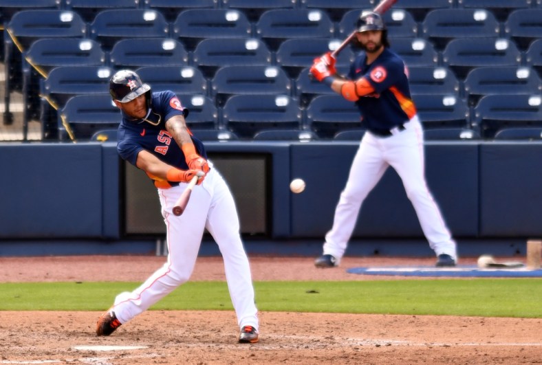 Feb 28, 2021; West Palm Beach, Florida, USA; Houston Astros outfielder Jose Siri (99) hits a single against the Miami Marlins in the seventh inning during a spring training game at Ballpark of the Palm Beaches. Mandatory Credit: Jim Rassol-USA TODAY Sports
