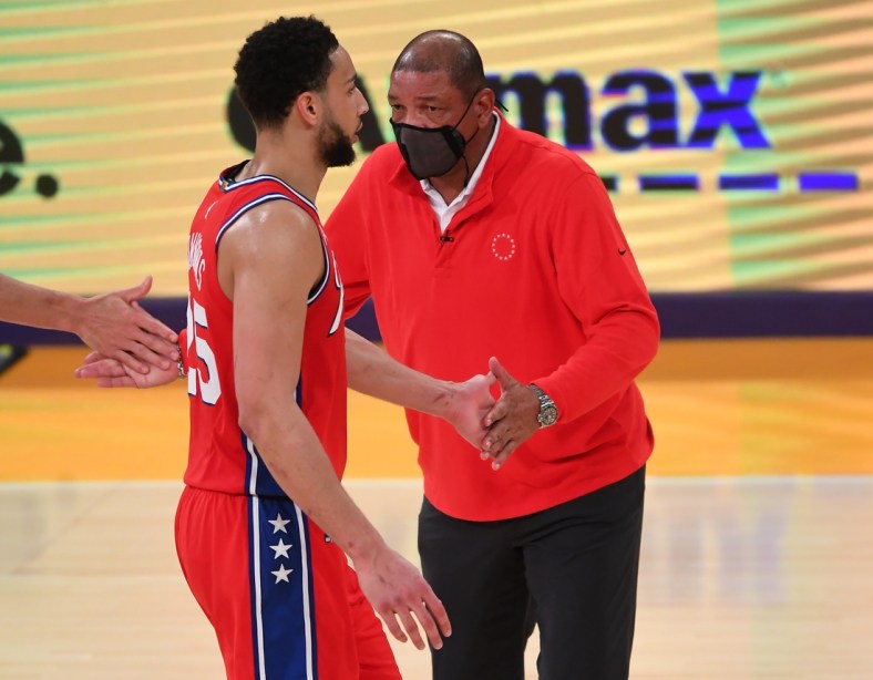 Mar 25, 2021; Los Angeles, California, USA;  Philadelphia 76ers guard Ben Simmons (25) is greeted by head coach Doc Rivers during a time out in the second half of the game against the Los Angeles Lakers at Staples Center. Mandatory Credit: Jayne Kamin-Oncea-USA TODAY Sports
