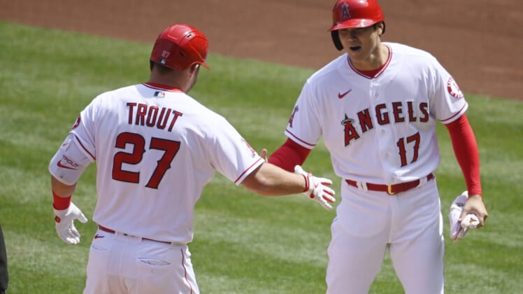 Apr 6, 2021; Anaheim, California, USA; Los Angeles Angels center fielder Mike Trout (27) celebrates his two-run home run with designated hitter Shohei Ohtani (17) during the first inning against the Houston Astros at Angel Stadium. Mandatory Credit: Kelvin Kuo-USA TODAY Sports