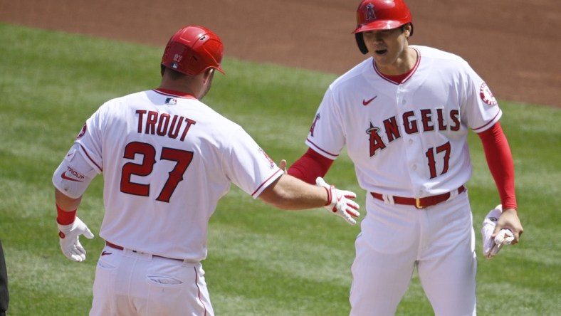 Apr 6, 2021; Anaheim, California, USA; Los Angeles Angels center fielder Mike Trout (27) celebrates his two-run home run with designated hitter Shohei Ohtani (17) during the first inning against the Houston Astros at Angel Stadium. Mandatory Credit: Kelvin Kuo-USA TODAY Sports