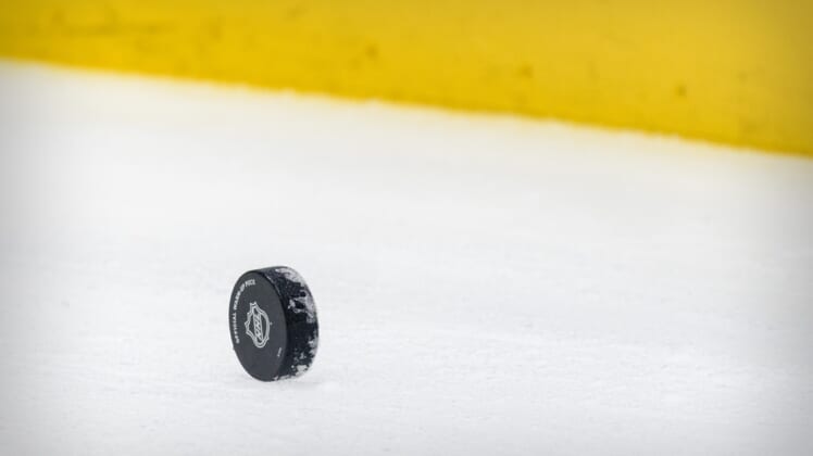Apr 20, 2021; Dallas, Texas, USA; A view of a hockey puck and yellow boards before the game between the Dallas Stars and the Detroit Red Wings at the American Airlines Center. Mandatory Credit: Jerome Miron-USA TODAY Sports