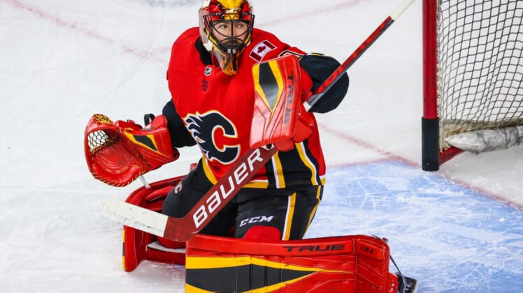 Apr 23, 2021; Calgary, Alberta, CAN; Calgary Flames goaltender Louis Domingue (70) guards his net during the warmup period against the Montreal Canadiens at Scotiabank Saddledome. Mandatory Credit: Sergei Belski-USA TODAY Sports