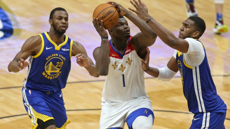 May 4, 2021; New Orleans, Louisiana, USA; New Orleans Pelicans forward Zion Williamson (1) drives on  Golden State Warriors forward Kevon Looney (5) in the third quarter at the Smoothie King Center. Mandatory Credit: Chuck Cook-USA TODAY Sports