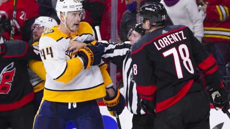 May 17, 2021; Raleigh, North Carolina, USA; Nashville Predators defenseman Erik Gudbranson (44) goes after Carolina Hurricanes left wing Steven Lorentz (78) during the second period in game one of the first round of the 2021 Stanley Cup Playoffs at PNC Arena. Mandatory Credit: James Guillory-USA TODAY Sports