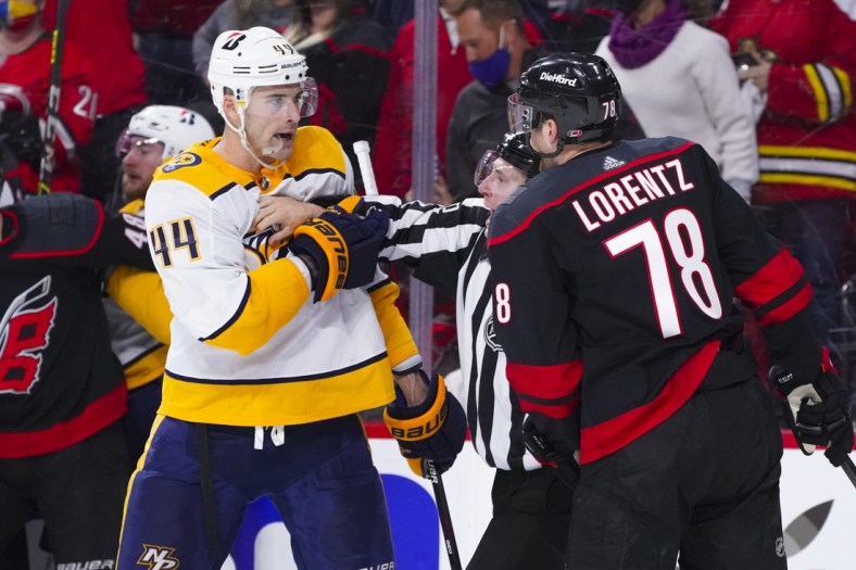 May 17, 2021; Raleigh, North Carolina, USA; Nashville Predators defenseman Erik Gudbranson (44) goes after Carolina Hurricanes left wing Steven Lorentz (78) during the second period in game one of the first round of the 2021 Stanley Cup Playoffs at PNC Arena. Mandatory Credit: James Guillory-USA TODAY Sports