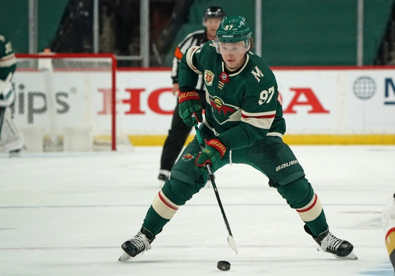 May 22, 2021; Saint Paul, Minnesota, USA; Minnesota Wild left wing Kirill Kaprizov (97) skates with the puck against the Vegas Golden Knights in game four of the first round of the 2021 Stanley Cup Playoffs at Xcel Energy Center. Mandatory Credit: Nick Wosika-USA TODAY Sports