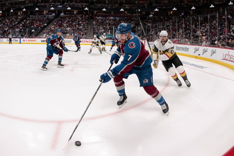 Jun 8, 2021; Denver, Colorado, USA; Colorado Avalanche defenseman Devon Toews (7) controls the puck ahead of Vegas Golden Knights defenseman Shea Theodore (27) in the second period in game five of the second round of the 2021 Stanley Cup Playoffs at Ball Arena. Mandatory Credit: Isaiah J. Downing-USA TODAY Sports