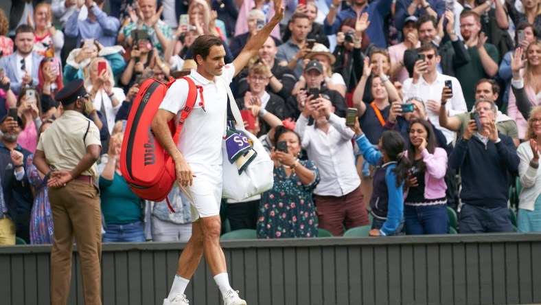 Jul 7, 2021; London, United Kingdom; Roger Federer (SUI) waving farewell to the Centre Court fans after losing to Hubert Hurkacz (POL) in the quarter finals at All England Lawn Tennis and Croquet Club. Mandatory Credit: Peter van den Berg-USA TODAY Sports