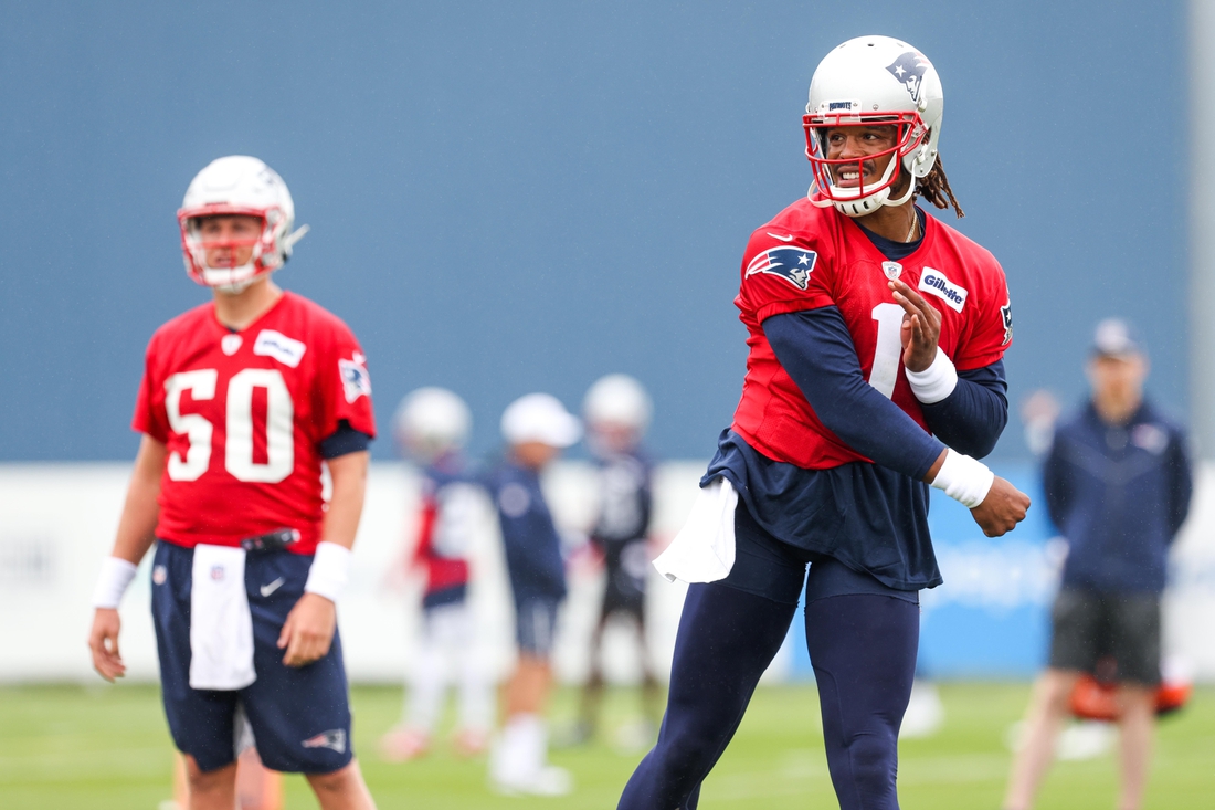 Jul 28, 2021; Foxborough, MA, United States; New England Patriots quarterback Mac Jones (50) watches New England Patriots quarterback Cam Newton (1) during training camp at Gillette Stadium. Mandatory Credit: Paul Rutherford-USA TODAY Sports