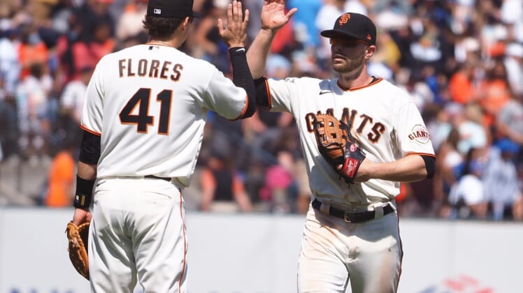 Jul 29, 2021; San Francisco, California, USA; San Francisco Giants third baseman Wilmer Flores (41) celebrates with left fielder Austin Slater (13) after a win against the Los Angeles Dodgers at Oracle Park. Mandatory Credit: Kelley L Cox-USA TODAY Sports