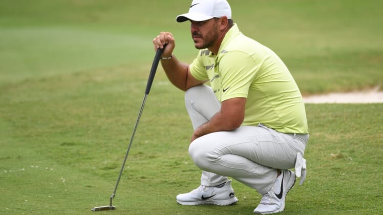 Aug 6, 2021; Memphis, Tennessee, USA; Brooks Koepka waits to putt on the fifth hole during the second round of the WGC FedEx St. Jude Invitational golf tournament at TPC Southwind. Mandatory Credit: Christopher Hanewinckel-USA TODAY Sports