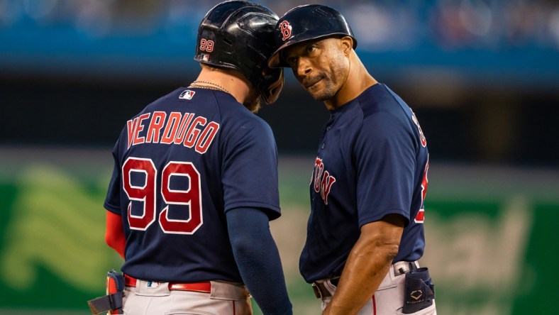 Aug 6, 2021; Toronto, Ontario, CAN; Boston Red Sox left fielder Alex Verdugo (99) celebrates hitting a single against the Toronto Blue Jays with first base coach Tom Goodwin (82) during the fourth inning at Rogers Centre. Mandatory Credit: Kevin Sousa-USA TODAY Sports