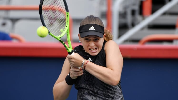 Aug 9, 2021; Montreal, Quebec, Canada; Jelena Ostapenko of Latvia hits a shot against Katerina Siniakova of the Czech Republic (not pictured) during first round play at Stade IGA. Mandatory Credit: Eric Bolte-USA TODAY Sports