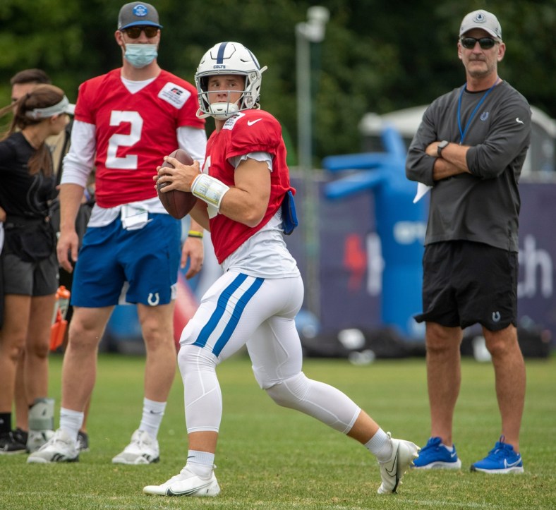 Indianapolis Colts quarterback Sam Ehlinger (4) drops back to pass as he is watched by Carson Wentz and Indianapolis Colts head coach Frank Reich during a combined Indianapolis Colts and Carolina Panthers practice at Grand Park in Westfield on Thursday, August 12, 2021, during Colts camp.Colts Entertain Panthers