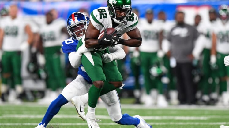 Aug 14, 2021; East Rutherford, New Jersey, USA; New York Jets wide receiver Jamison Crowder (82) runs the ball against New York Giants cornerback Darnay Holmes (30) during the first half at MetLife Stadium. Mandatory Credit: Dennis Schneidler-USA TODAY Sports