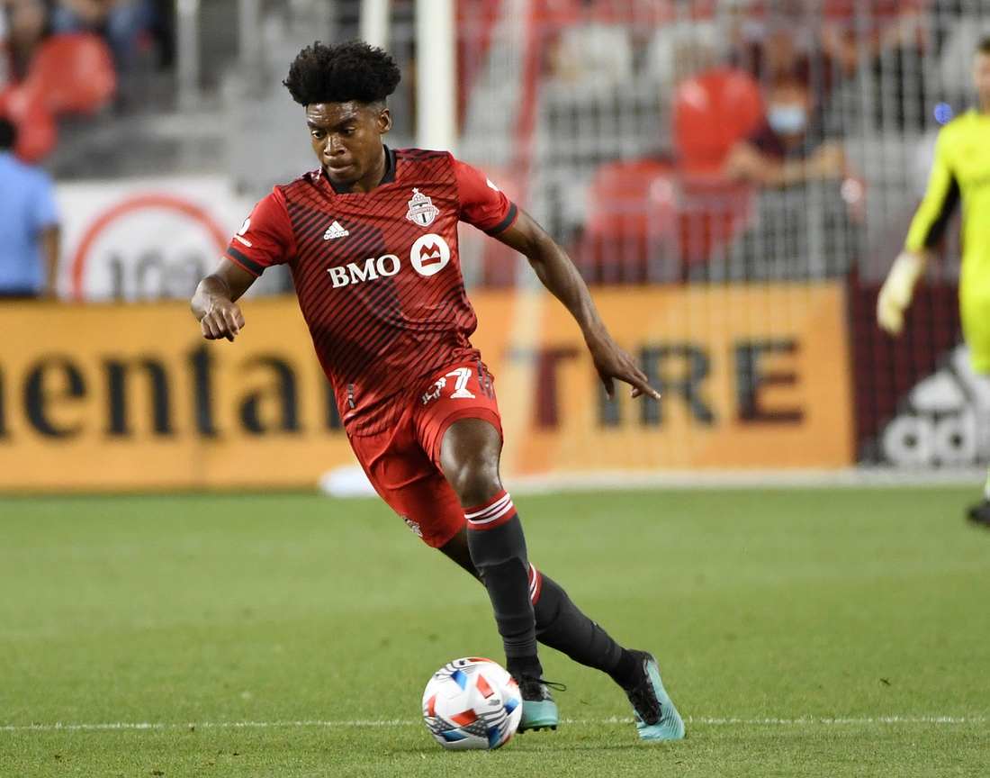 Aug 14, 2021; Toronto, Ontario, CAN;  Toronto FC midfielder Ralph Priso-Mbongue (97) advances the ball upfield against New England Revolution in the first half at BMO Field. Mandatory Credit: Dan Hamilton-USA TODAY Sports