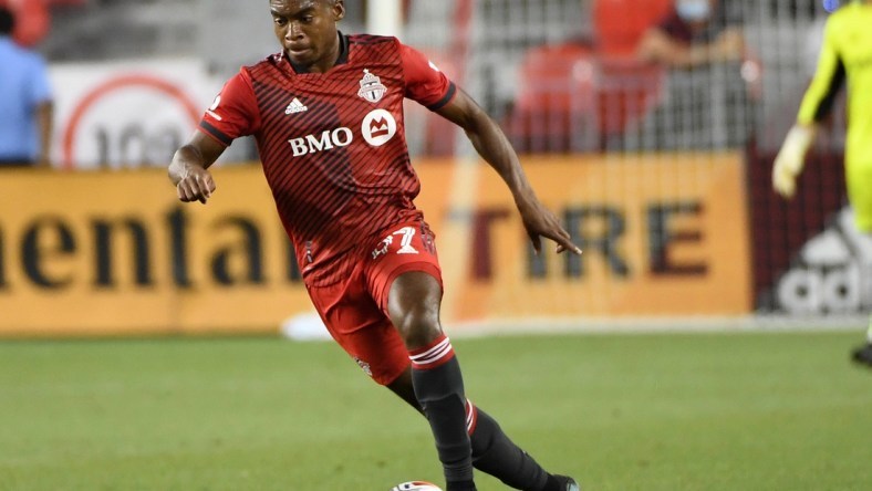 Aug 14, 2021; Toronto, Ontario, CAN;  Toronto FC midfielder Ralph Priso-Mbongue (97) advances the ball upfield against New England Revolution in the first half at BMO Field. Mandatory Credit: Dan Hamilton-USA TODAY Sports