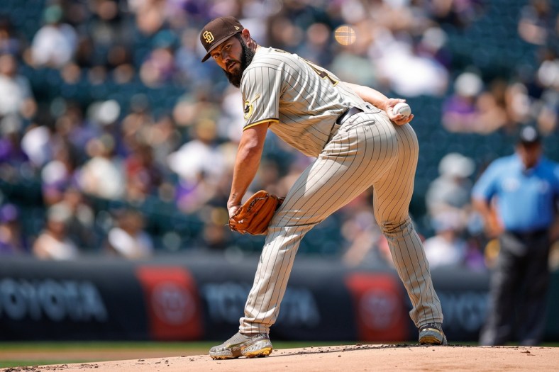 Aug 18, 2021; Denver, Colorado, USA; San Diego Padres starting pitcher Jake Arrieta (49) looks to first from the mound in the first inning against the Colorado Rockies at Coors Field. Mandatory Credit: Isaiah J. Downing-USA TODAY Sports