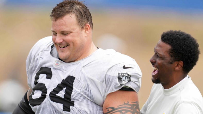 Aug 18, 2021; Thousand Oaks, CA, USA; Las Vegas Raiders  guard Richie Incognito (64) interacts with Los Angeles Rams vice president of communications Artis Twyman during a joint practice. Mandatory Credit: Kirby Lee-USA TODAY Sports