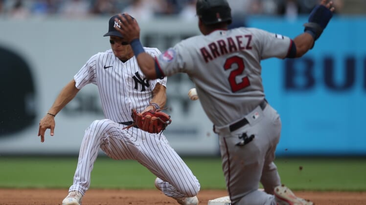 Aug 21, 2021; Bronx, New York, USA; Minnesota Twins third baseman Luis Arraez (2) steals second base as New York Yankees shortstop Andrew Velazquez (71) mishandles the throw during the fourth inning at Yankee Stadium. Mandatory Credit: Brad Penner-USA TODAY Sports