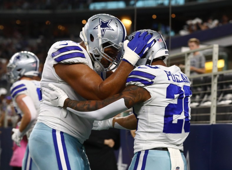 Aug 21, 2021; Arlington, Texas, USA; Dallas Cowboys running back Tony Pollard (20) celebrates a first quarter touchdown with tackle La'el Collins (71) against the Houston Texans at AT&T Stadium. Mandatory Credit: Matthew Emmons-USA TODAY Sports