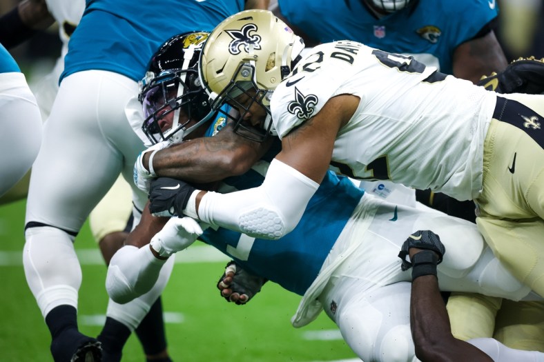 Aug 23, 2021; New Orleans, Louisiana, USA;  New Orleans Saints defensive end Marcus Davenport (92) tackles Jacksonville Jaguars running back Nathan Cottrell (31) during the first half at Caesars Superdome. Mandatory Credit: Stephen Lew-USA TODAY Sports