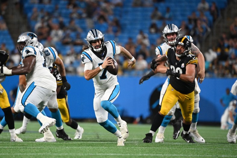 Aug 27, 2021; Charlotte, North Carolina, USA;  Carolina Panthers quarterback Will Grier (7) runs for a touchdown as Pittsburgh Steelers defensive end Isaiahh Loudermilk (92) defends in the fourth quarter at Bank of America Stadium. Mandatory Credit: Bob Donnan-USA TODAY Sports