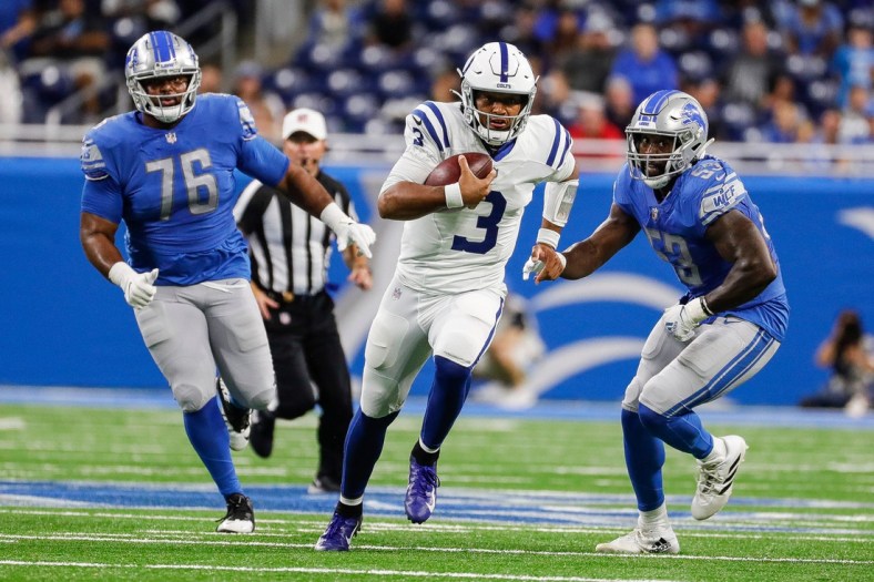 Indianapolis Colts quarterback Brett Hundley (3) runs against Detroit Lions defensive end Bruce Hector (76) and  linebacker Charles Harris (53) during the second half of a preseason game at Ford Field in Detroit on Friday, Aug. 27, 2021.