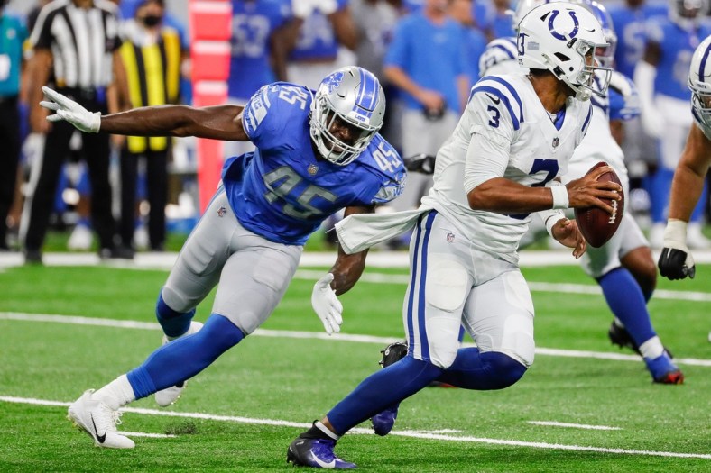 Detroit Lions linebacker Rashod Berry (45) tries to stop Indianapolis Colts quarterback Brett Hundley (3) during the second half of a preseason game at Ford Field in Detroit on Friday, Aug. 27, 2021.