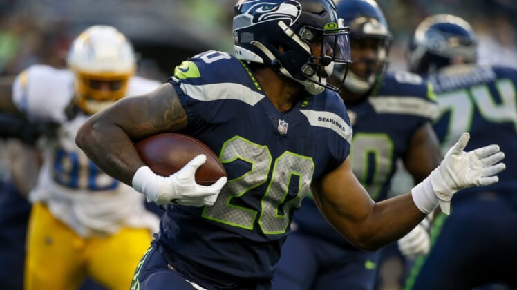 Aug 28, 2021; Seattle, Washington, USA; Seattle Seahawks running back Rashaad Penny (20) rushes against the Los Angeles Chargers during the first quarter at Lumen Field. Mandatory Credit: Joe Nicholson-USA TODAY Sports