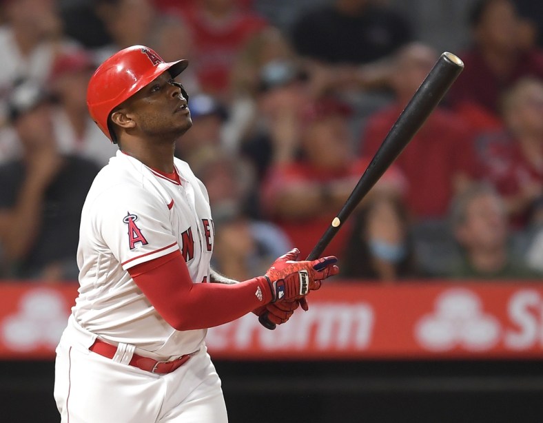 Aug 28, 2021; Anaheim, California, USA; Los Angeles Angels left fielder Justin Upton (10) hits a sacrifice fly for his 1,000th RBI scoring third baseman Phil Gosselin (13) in the fifth inning against the San Diego Padres at Angel Stadium. Mandatory Credit: Jayne Kamin-Oncea-USA TODAY Sports