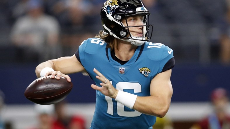 Aug 29, 2021; Arlington, Texas, USA; Jacksonville Jaguars quarterback Trevor Lawrence (16) rolls out to throw a pass in the first quarter against the Dallas Cowboys at AT&T Stadium. Mandatory Credit: Tim Heitman-USA TODAY Sports