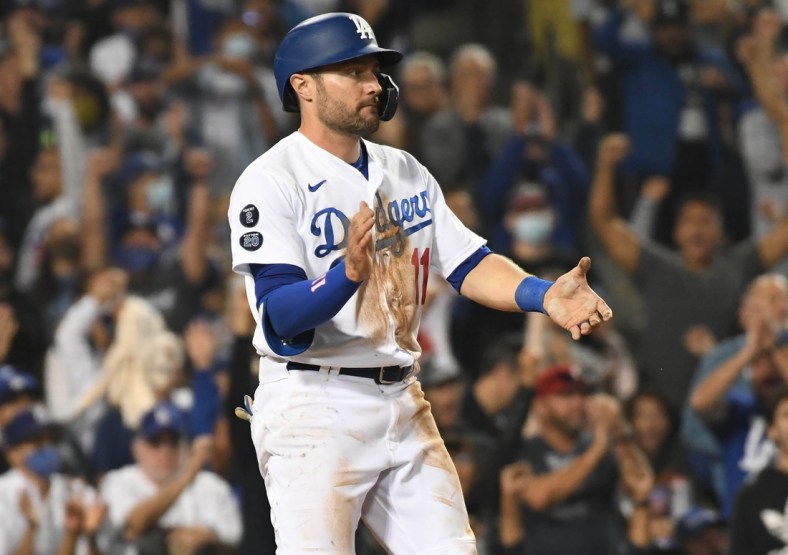 Aug 31, 2021; Los Angeles, California, USA; Los Angeles Dodgers left fielder AJ Pollock (11) reacts after scoring a run against the Atlanta Braves during the seventh inning at Dodger Stadium. Mandatory Credit: Richard Mackson-USA TODAY Sports