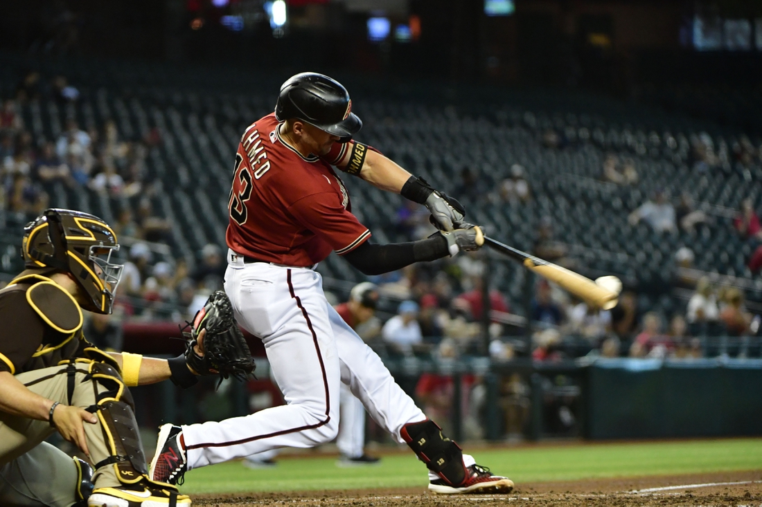 Sep 1, 2021; Phoenix, Arizona, USA; Arizona Diamondbacks shortstop Nick Ahmed (13) hits an RBI single in the third inning against the San Diego Padres at Chase Field. Mandatory Credit: Matt Kartozian-USA TODAY Sports