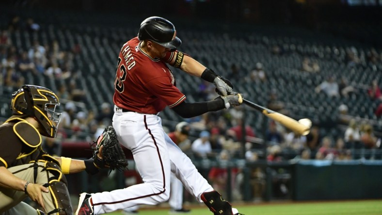 Sep 1, 2021; Phoenix, Arizona, USA; Arizona Diamondbacks shortstop Nick Ahmed (13) hits an RBI single in the third inning against the San Diego Padres at Chase Field. Mandatory Credit: Matt Kartozian-USA TODAY Sports