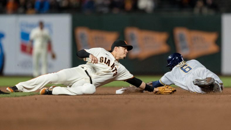 Sep 1, 2021; San Francisco, California, USA; Milwaukee Brewers center fielder Lorenzo Cain (6) dives safely into second base after San Francisco Giants third baseman Wilmer Flores (41) is late with the tag in the fifth inning at Oracle Park. Mandatory Credit: John Hefti-USA TODAY Sports