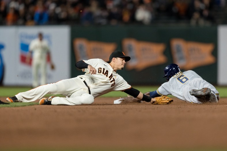 Sep 1, 2021; San Francisco, California, USA; Milwaukee Brewers center fielder Lorenzo Cain (6) dives safely into second base after San Francisco Giants third baseman Wilmer Flores (41) is late with the tag in the fifth inning at Oracle Park. Mandatory Credit: John Hefti-USA TODAY Sports