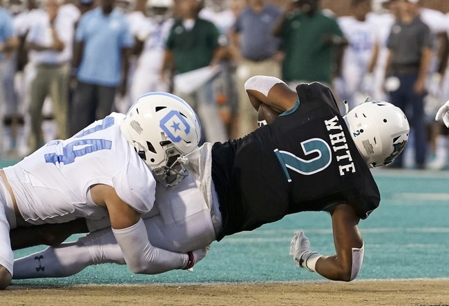 Sep 2, 2021; Conway, South Carolina, USA; Coastal Carolina Chanticleers running back Reese White (2) scores against Citadel Bulldogs defensive back Wilson Hendricks III (24) in the second quarter at Brooks Stadium. Mandatory Credit: David Yeazell-USA TODAY Sports