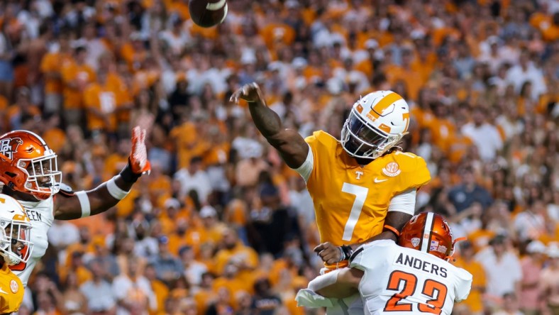 Sep 2, 2021; Knoxville, Tennessee, USA; Tennessee Volunteers quarterback Joe Milton III (7) throws the ball against Bowling Green Falcons linebacker Darren Anders (23) during the first quarter at Neyland Stadium. Mandatory Credit: Randy Sartin-USA TODAY Sports