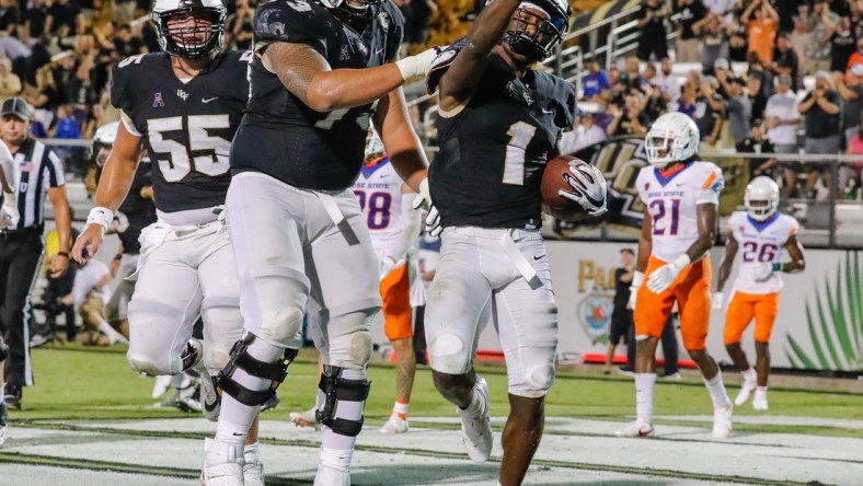 Sep 3, 2021; Orlando, Florida, USA; UCF Knights wide receiver Jaylon Robinson (1) celebrates with offensive lineman Samuel Jackson (73) after scoring a touchdown against the Boise State Broncos during the second half at Bounce House. Mandatory Credit: Mike Watters-USA TODAY Sports