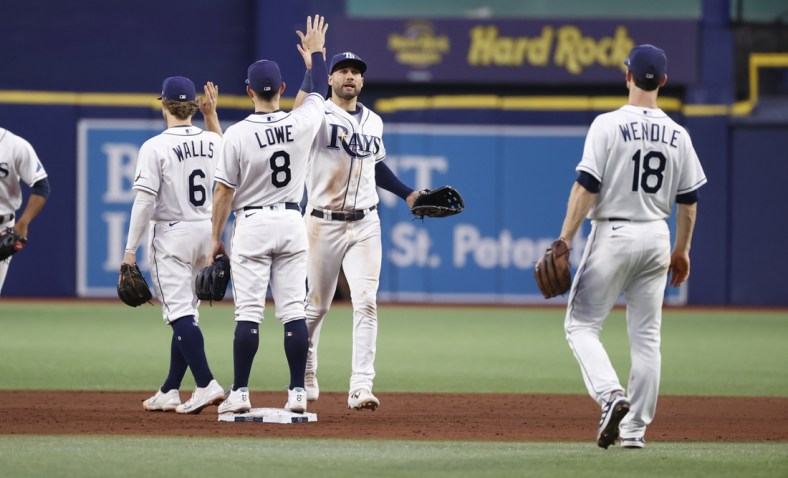 Sep 3, 2021; St. Petersburg, Florida, USA;  Tampa Bay Rays center fielder Kevin Kiermaier (39), second baseman Brandon Lowe (8) and teammates high five as they beat the Minnesota Twins at Tropicana Field. Mandatory Credit: Kim Klement-USA TODAY Sports