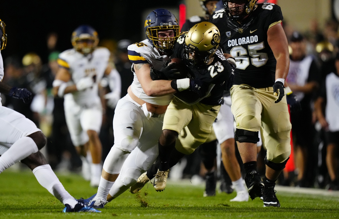 Sep 3, 2021; Boulder, Colorado, USA; Northern Colorado Bears defensive lineman Joe Golden (95) tackles Colorado Buffaloes running back Jarek Broussard (23) after a thirty yard carry n the second quarter at Folsom Field. Mandatory Credit: Ron Chenoy-USA TODAY Sports