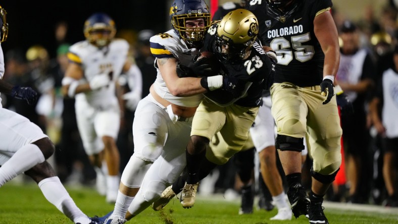 Sep 3, 2021; Boulder, Colorado, USA; Northern Colorado Bears defensive lineman Joe Golden (95) tackles Colorado Buffaloes running back Jarek Broussard (23) after a thirty yard carry n the second quarter at Folsom Field. Mandatory Credit: Ron Chenoy-USA TODAY Sports