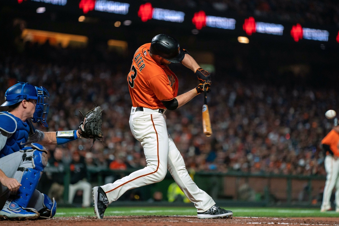 Sep 3, 2021; San Francisco, California, USA;  San Francisco Giants right fielder Austin Slater (13) hits a RBI single against the Los Angeles Dodgers during the third inning at Oracle Park. Mandatory Credit: Neville E. Guard-USA TODAY Sports