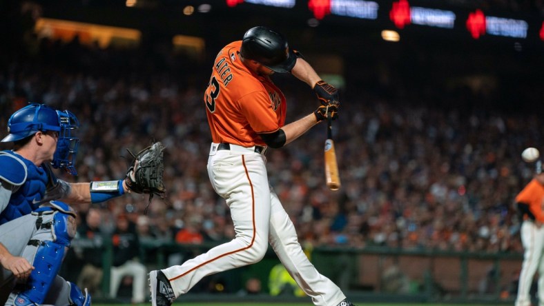 Sep 3, 2021; San Francisco, California, USA;  San Francisco Giants right fielder Austin Slater (13) hits a RBI single against the Los Angeles Dodgers during the third inning at Oracle Park. Mandatory Credit: Neville E. Guard-USA TODAY Sports